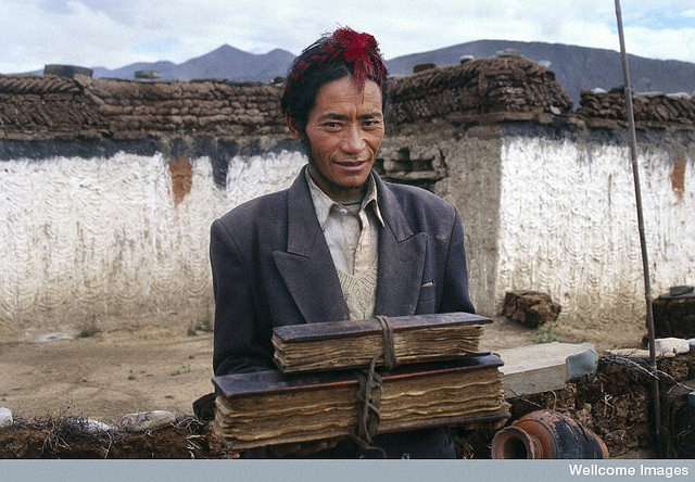A Tibetan doctor holding his family's medical texts (Theresia Hofer, Wellcome Images: https://www.flickr.com/photos/wellcomeimages/14933009688/)