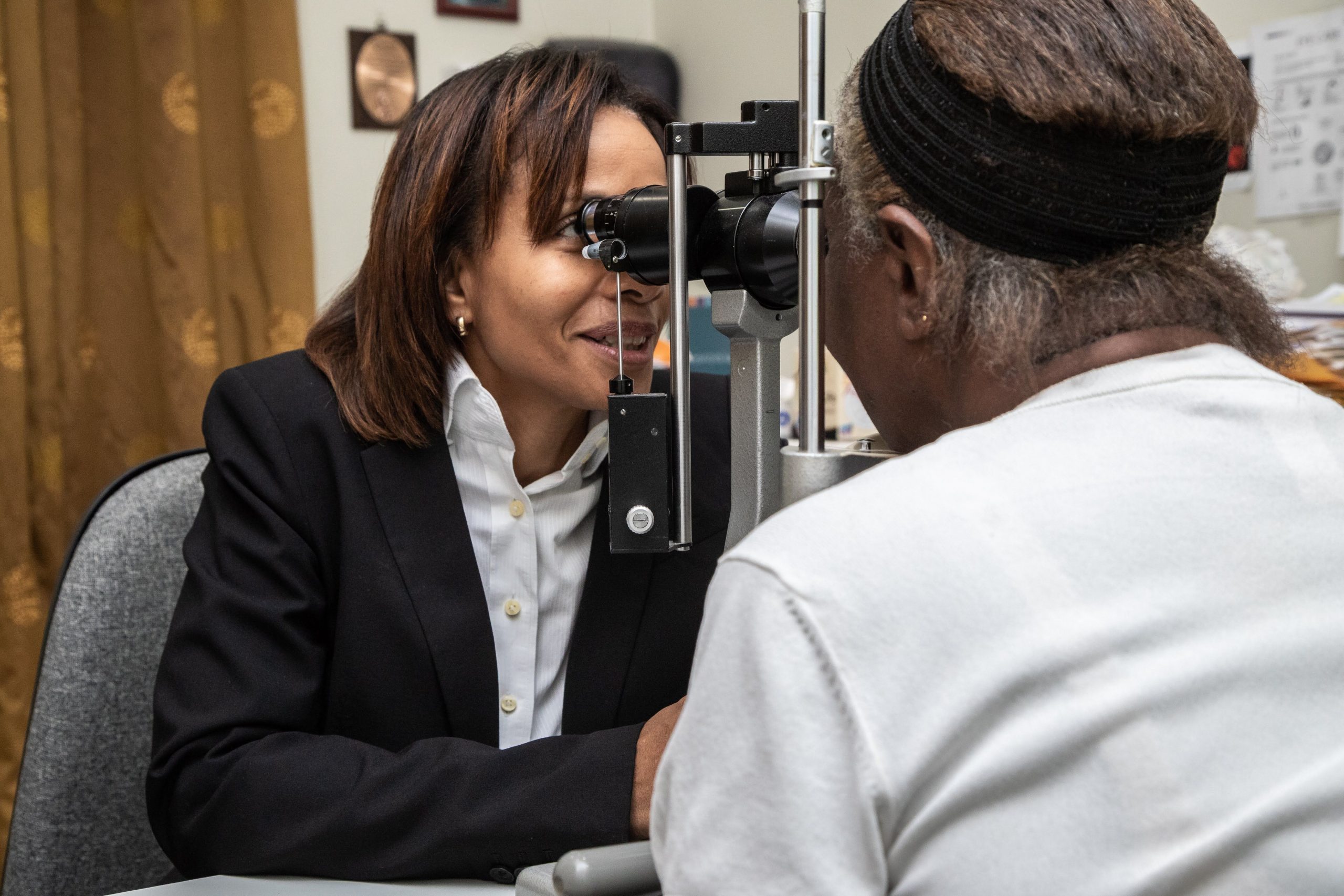 In Dominica, a doctor assesses a patient at a slit lamp 