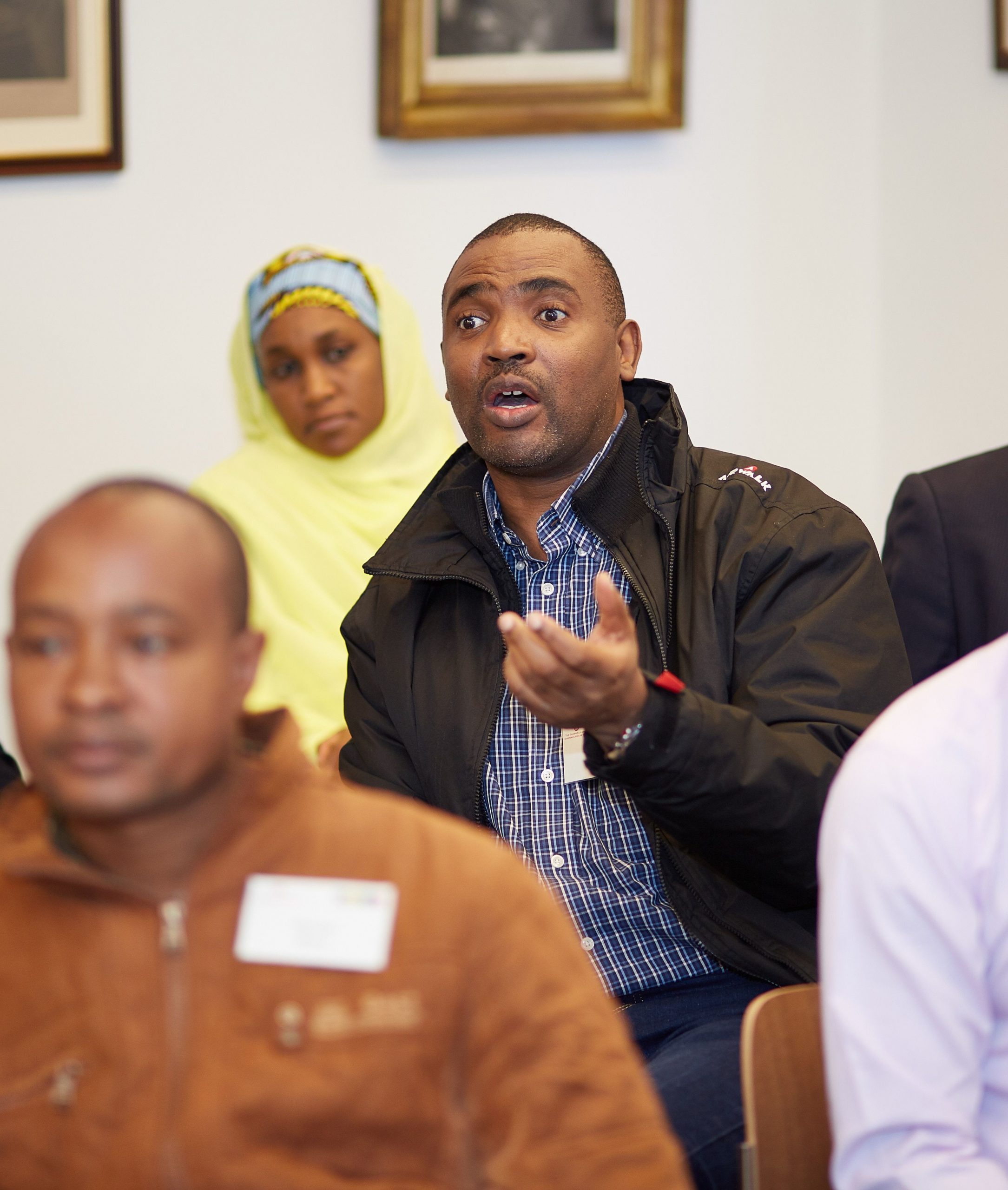 a man asks a question at a meeting 