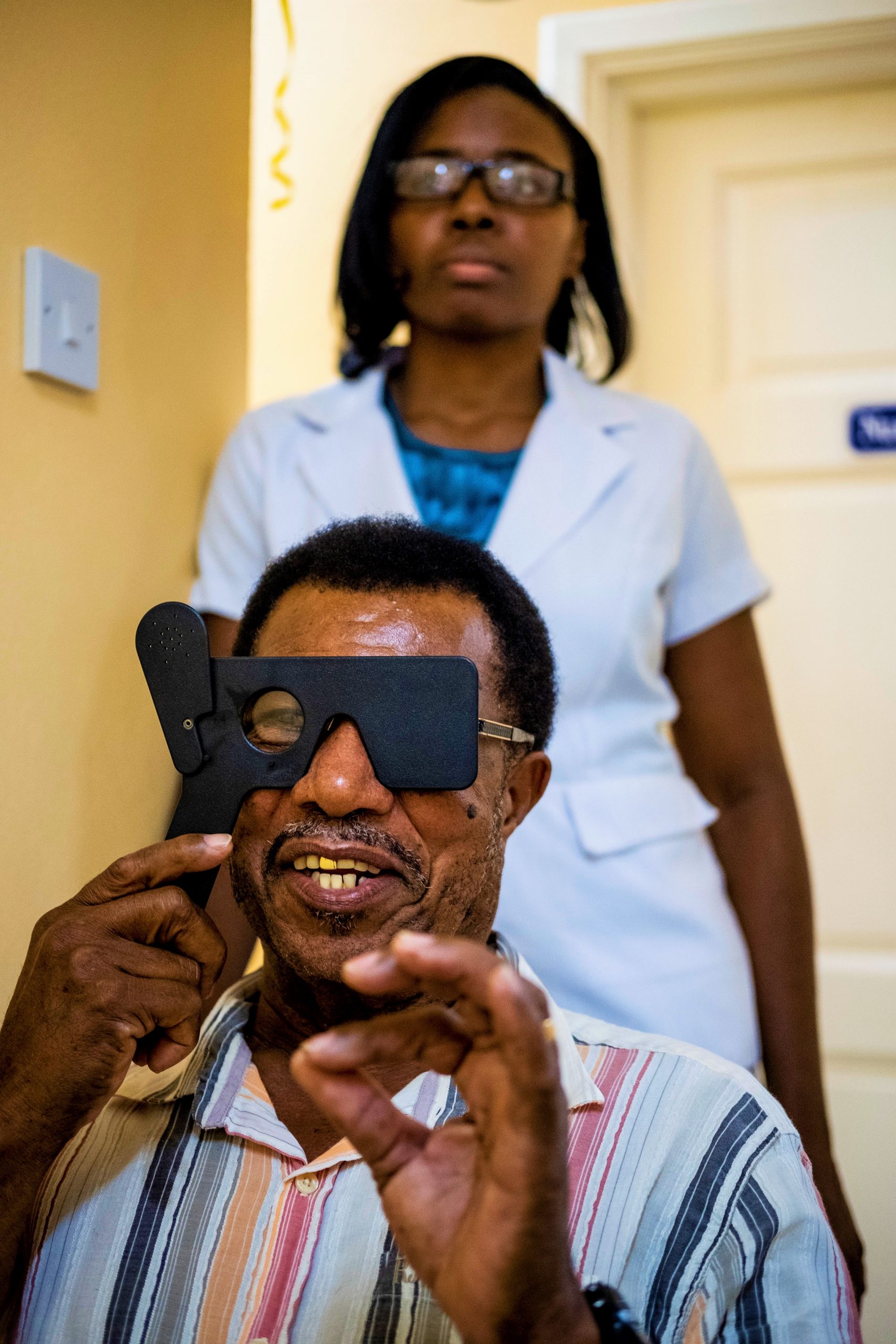 In St Lucia, a man has his eyes tested with an eye occluder