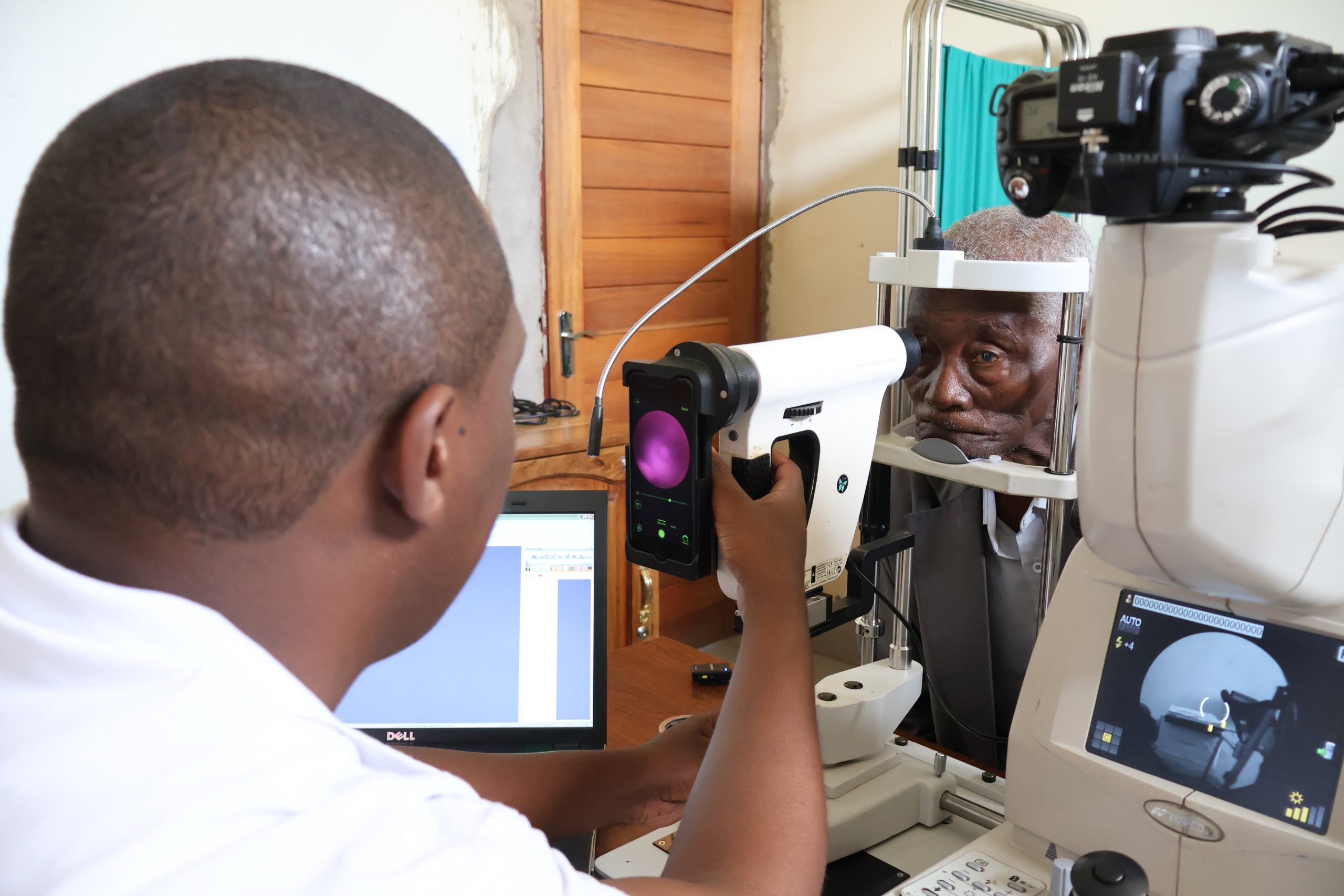 In Tanzania, a doctor images a patient's retina using a smartphone-based device 