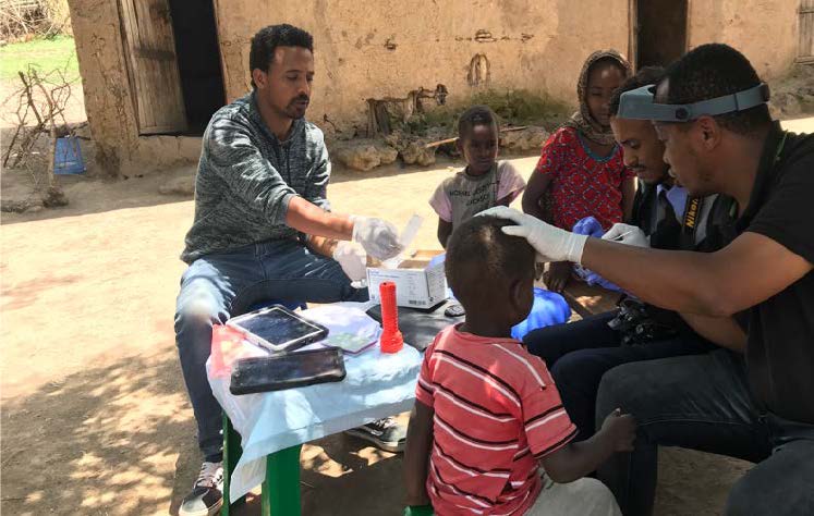 in Ethiopia, a team swabs children's eyes