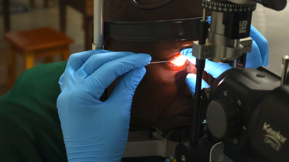 a woman has her cornea scraped for testing 