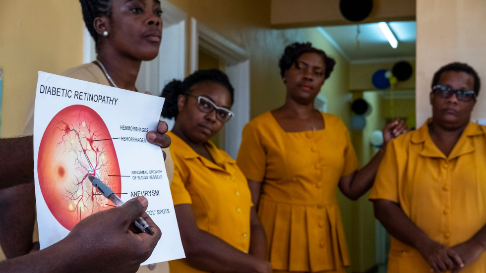 In St Lucia, a woman holds up a sheet saying 'diabetic retinopathy' as part of training 