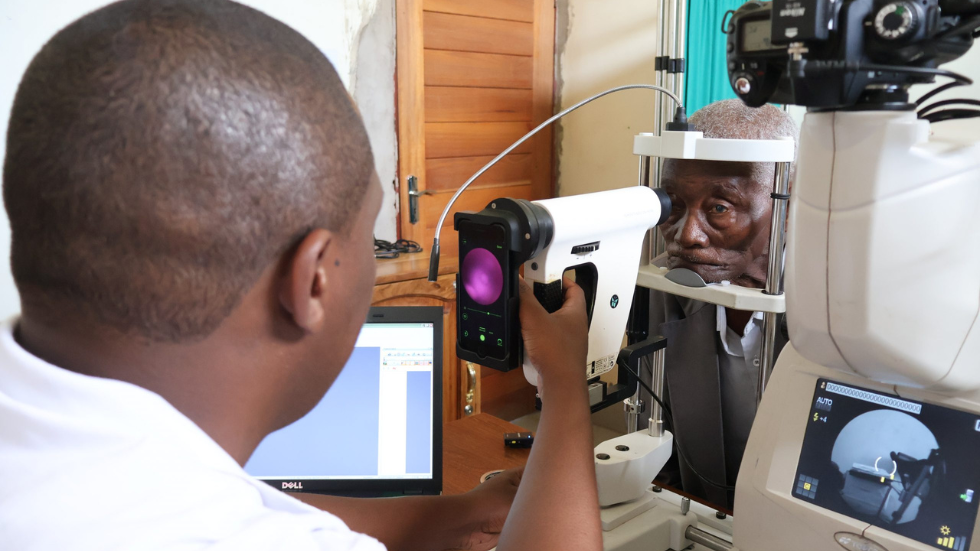 a doctor images a patient's retina using a smartphone integrated device 
