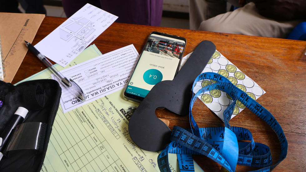 on a table, some patient health documents and an eye test