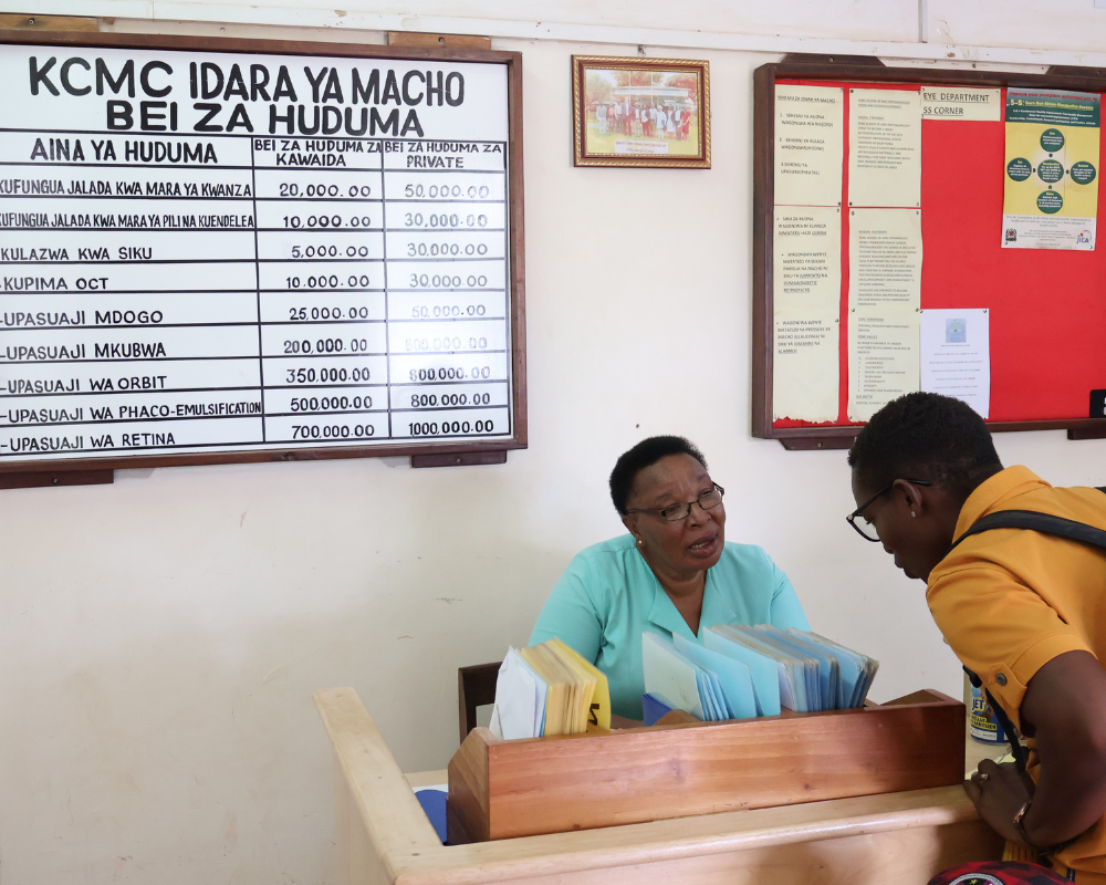 In Tanzania, a nurse works at the reception, checking people in 