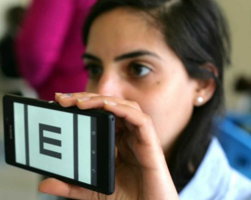 A woman holds a smartphone with an 'E' symbol for acuity 