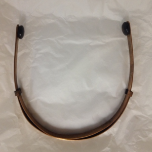 Ear plugs on an adjustable aluminium band, c. 1912 (Ross/159/01/62)