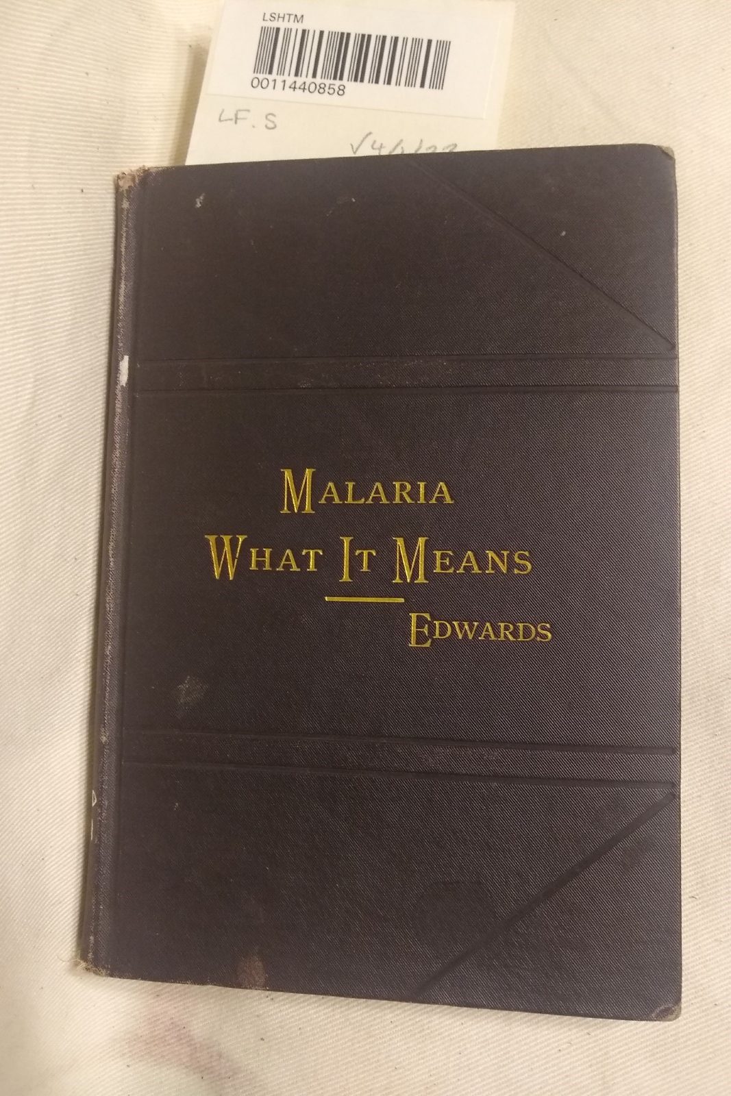 The cover of 'Malaria: what it means and how avoided,' in black with title and author surname in embossed gold letters.