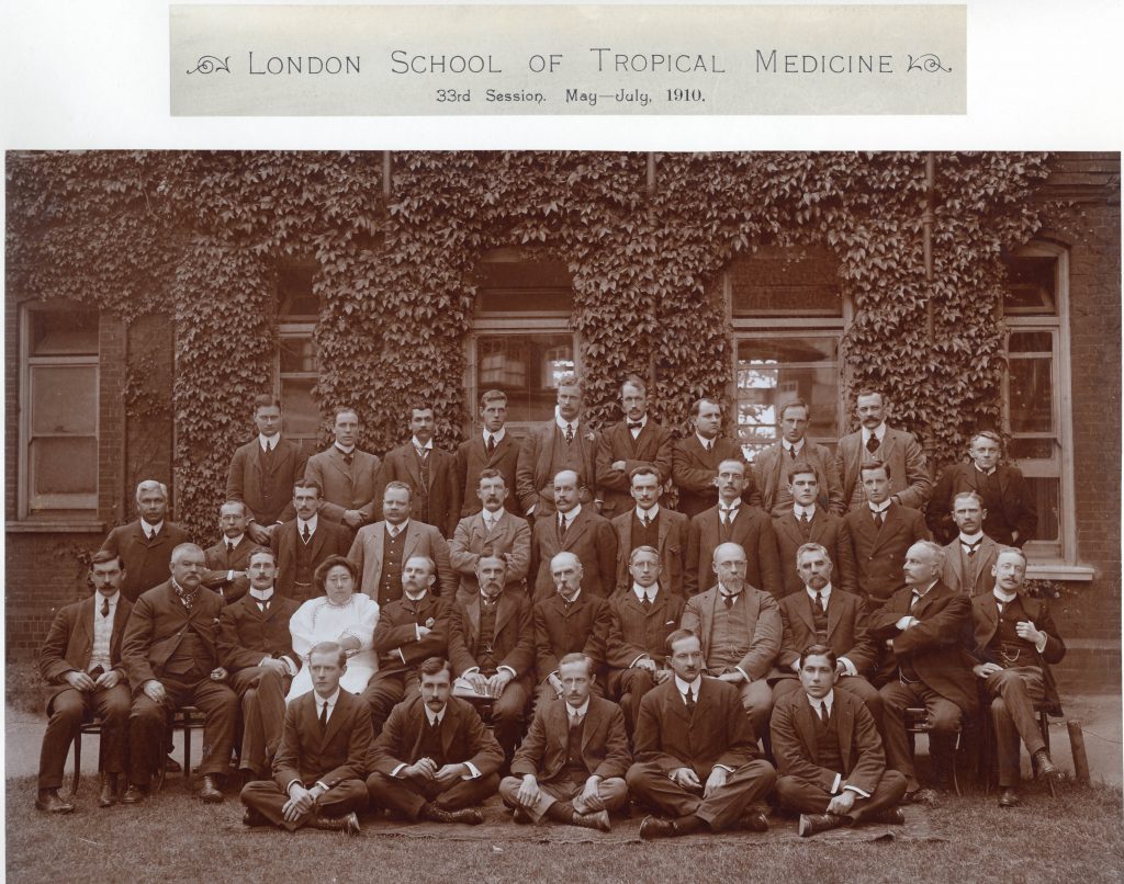 Black and white photograph of the 33rd Session at LSHTM. Shows four rows of men in suits and Ida Kahn in a white dress on the second row.