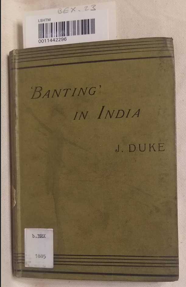Photograph of the front cover of Banting in India by J. Duke, with a yellowish green cloth cover embossed in black with the title and author.