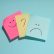 Photo showing three post-it notes with a happy face, a question mark, and a sad face.