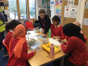 Claire discussing photos with school children