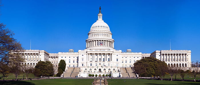 US Capitol Building under a blue sky.