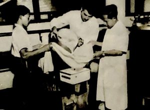 Photo showing three people sieving soya bean milk in Indonesia in 1955