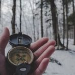 Image of hand holding a compass.