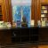 A desk in the library. With a bust in the middle surronded by books about